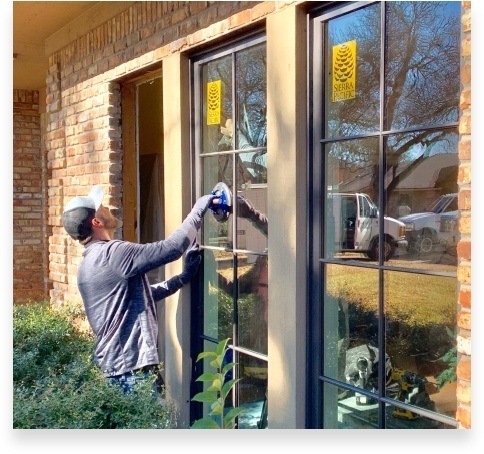Adooring Designs team member installing window in Dallas home